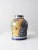 A vintage Talavera-style pottery vase featuring a classic urn silhouette and richly detailed hand-painted decoration. The...
