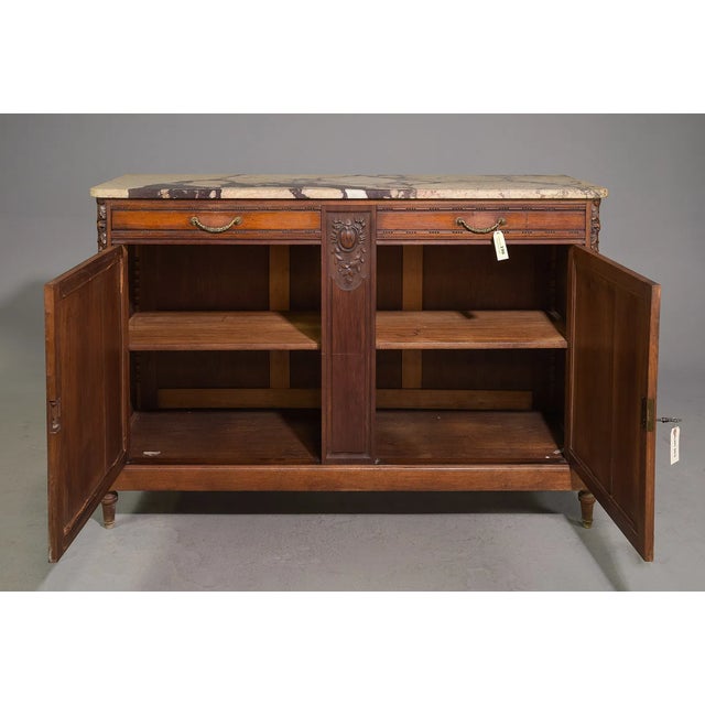 An exquisite 19th-century Louis XVI-style buffet that beautifully embodies the elegance and symmetry of classical French...