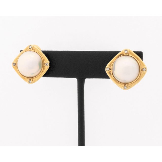 Pair of Mabe Pearl and Diamond 14K Yellow Gold Earrings, designed as 14K yellow gold square forms, decorated with two...