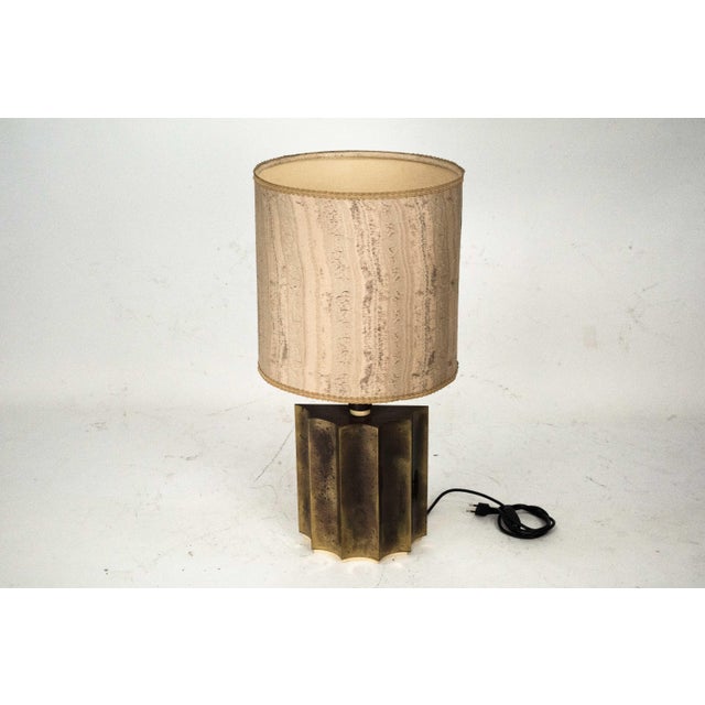 Elegant vintage table lamp featuring a brass base with a beautiful, naturally aged patina that enhances its character and...