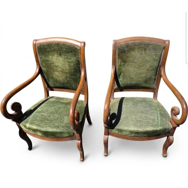 This pair of 19th-century Louis Philippe style armchairs features a classic design crafted from solid wood (typically...
