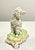 A striking example of German Dresden porcelain artistry, this elegant poodle figurine is richly decorated with intricate...