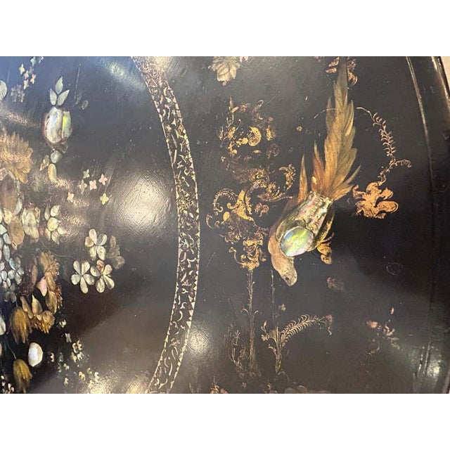 19th century English Regency black lacquer round dining or center table magnificently adorned with chinoiserie style...