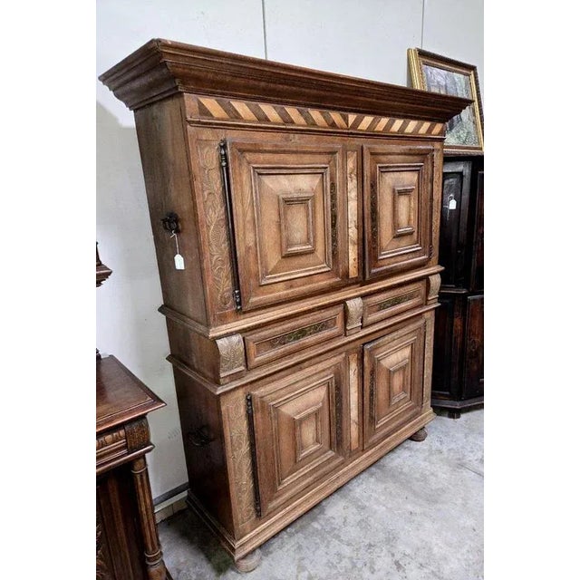 Montbéliard two-body cabinet sideboard in molded oak carved with foliage and foliage scrolls, opening to two leaves on the...