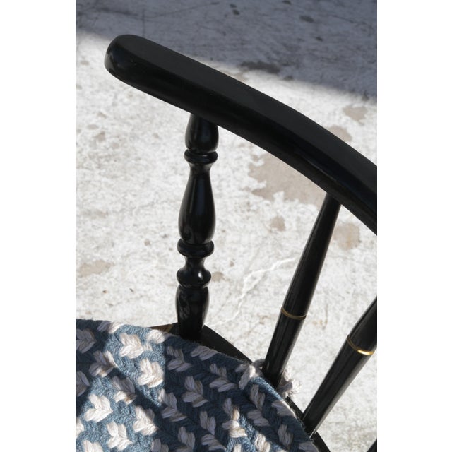 A beautiful japanned Nichols & Stone chinoiserie chair. The chair is in the japanned black hue, with gold stenciled...