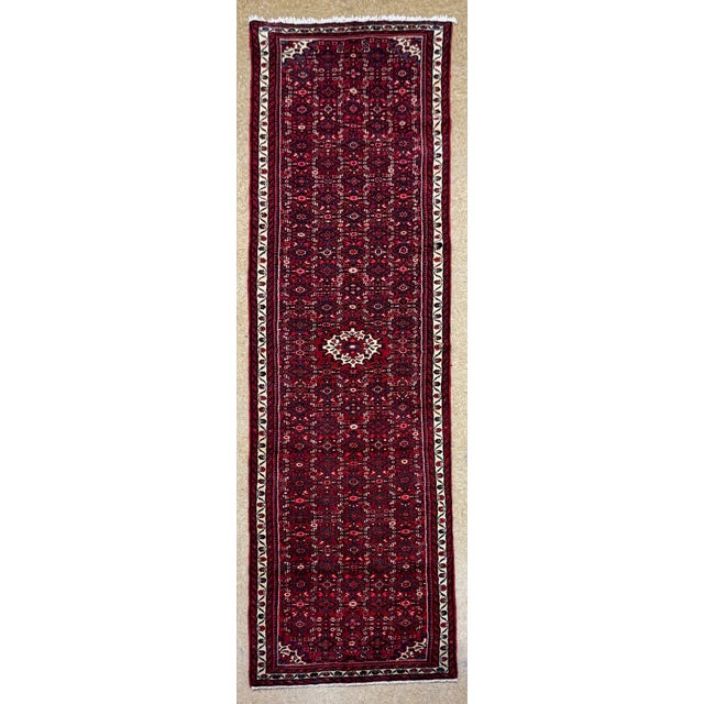 Hand-knotted long runner from the Hamadan region of western Iran, featuring a dense allover Herati (Mahi) pattern set...