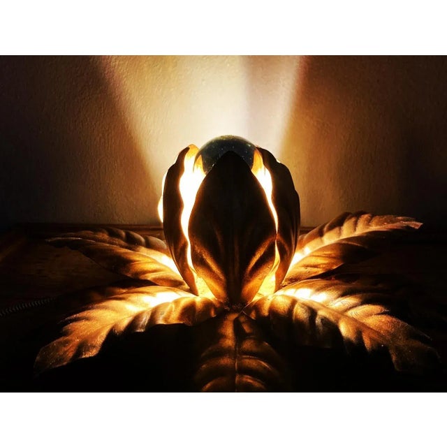 Beautiful vintage Italian wall lamp from the 1960s. This flower is made of gold-plated metal. It creates a warm...