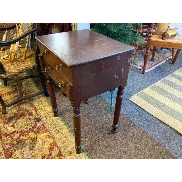 19th century side table. Two drawers, brass knobs. Turned legs and detail.