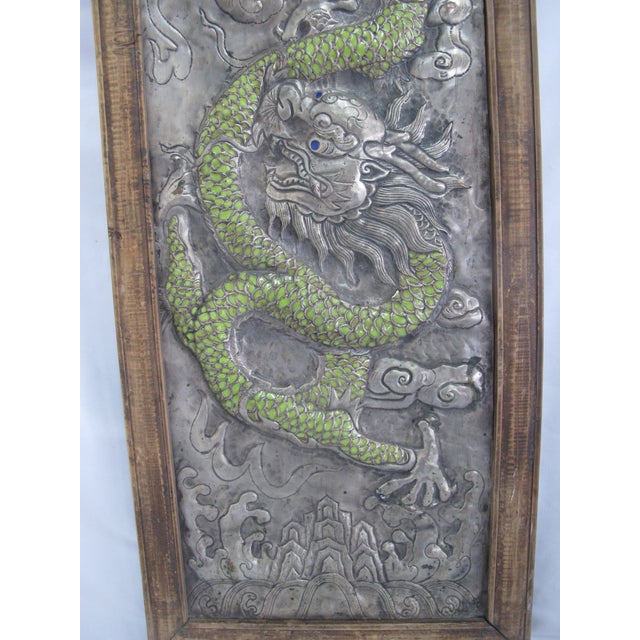 Chinese silver metal relief dragon panel, features detailed, silver-chased dragon with vibrant green enamel scales and...