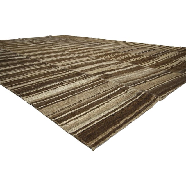 60632 Vintage Turkish Kilim Rug with Earth-Tone Colors, 10'01 x 14'02. Wabi-Sabi embraces rustic finesse in this handwoven...