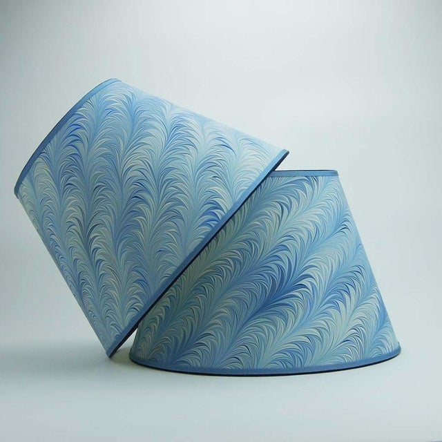 Marbled paper with an array of blues in a classic flame pattern; trimmed with two colors of grosgrain. Available in 3...