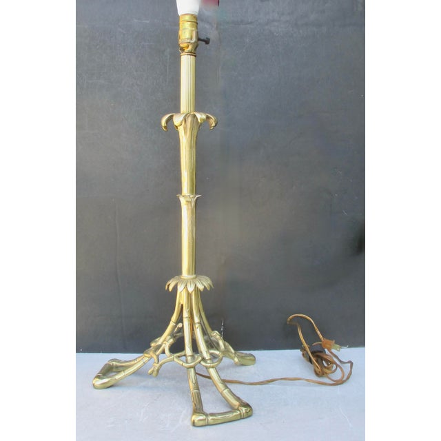 Vintage bronze table by Cailar Bayard, France. Finely carved frame of faux bamboo with a central column. Fitted with a...
