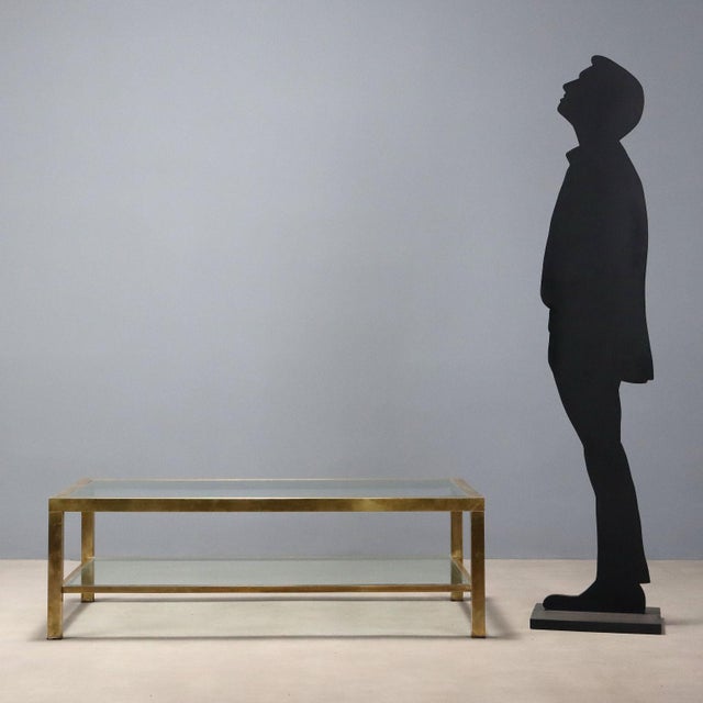 Coffee table with double top, brass-plated metal frame, glass. This piece is attributed to the mentioned designer/maker....