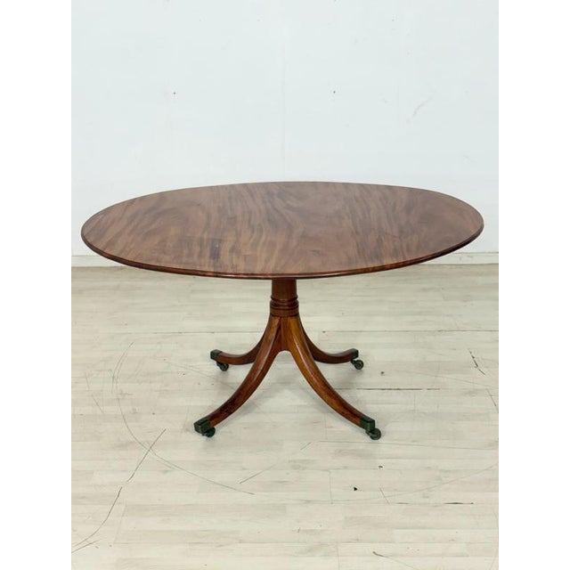 Beautiful vintage dining table from the 1960s in classic colonial style. The table impresses with its elegant shape, high-...