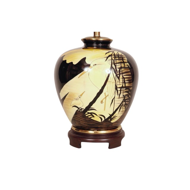 A hand painted Japanese ceramic table lamp. The vase is decorated on both sides with a mother and baby heron in the water,...