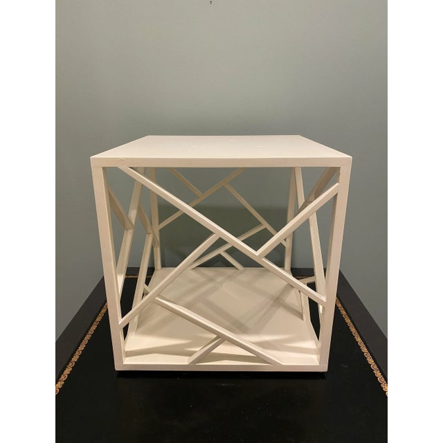 This is a modern ivory enamel cube occasional or side table. The sides of the table are open and designed like open...