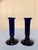 A striking pair of antique cobalt blue glass candlesticks, featuring elegant fluted column bodies and wide, rounded drip-...