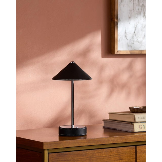 Illuminate your space with a touch of mid-century modern flair, courtesy of the Nomelle accent table lamp. Standing at an...