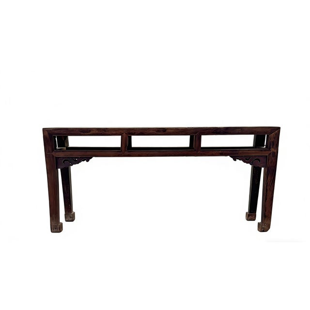 This antique Chinese altar bench showcases a blend of traditional craftsmanship with its decorative hand-carved spandrels....