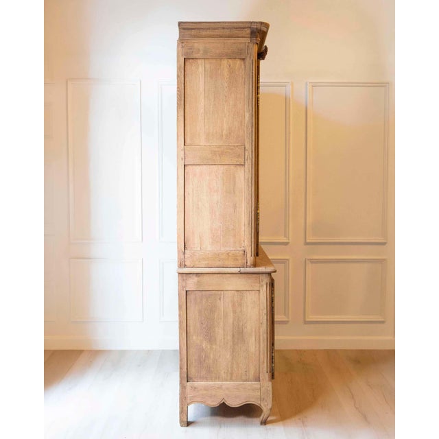 An exceptional early 19th century Norman two-part sideboard in richly patinated oak, showcasing the regional craftsmanship...