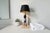 A stunning table lamp with a design attributed to jacques adnet, elegantly blending veined marble and chrome elements,...