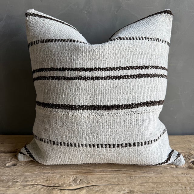 Creamy white hemp rug pillow with stripes. Soft hand, linen blend backing with zipper closure. Spot cleaning is...