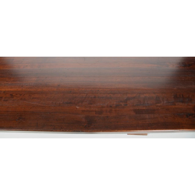 Antique trestle table. Stately and sturdy. Likely mahogany or cherry wood, early 20th Century. Thick rectangular top...