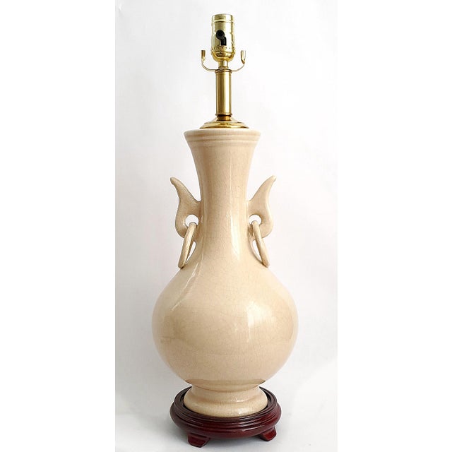 Offering a RESTORED light pink Chinese porcelain table lamp, circa 1960s. This beautiful traditional Chinese lamp has a...