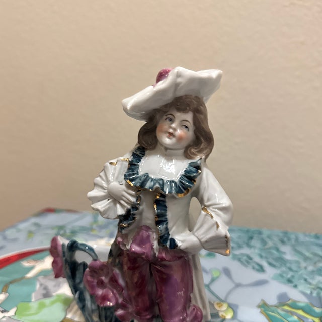 Add a touch of classical elegance to your home with this beautiful vintage porcelain figurine depicting a dandy or...