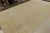 Hand Knotted in wool, this 9x13 antique Oushak rug has all over subdued floral patterns in gold and beige-brown accents....