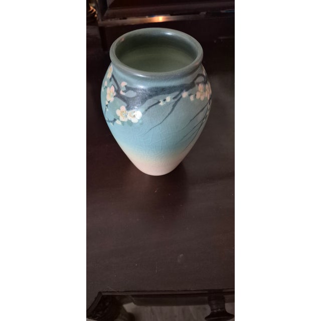 This is a Rookwood pottery vase style #915 called Floral Vellum, the glaze is Vellum for sure, not completely certain...