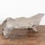 Worn and weathered through the elements, the seat of this teak root bench is one solid piece of wood, with the left end...