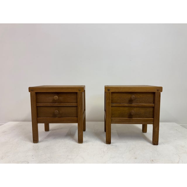 Pair of Brutalist Oak Bedside Cabinets, 1970s A charming pair of 1970s Brutalist bedside cabinets in solid oak, each with...