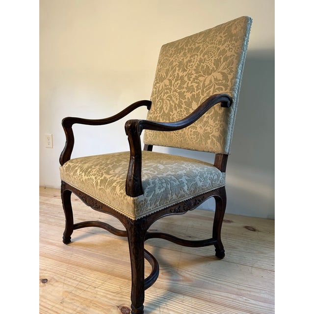 Elegant, hand carved walnut French armchair. Newly upholstered in a beautiful very soft sage green Italian Bergamo cut...