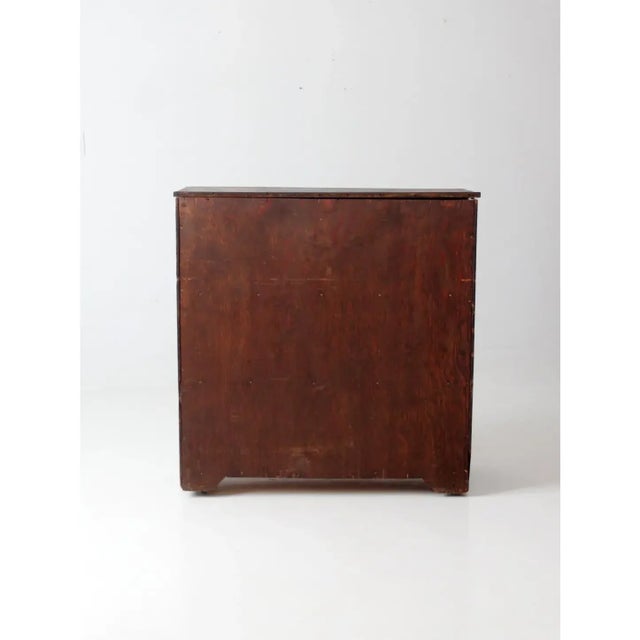 This antique primitive cupboard exudes understated rustic elegance, perfectly blending form and function. Crafted with a...