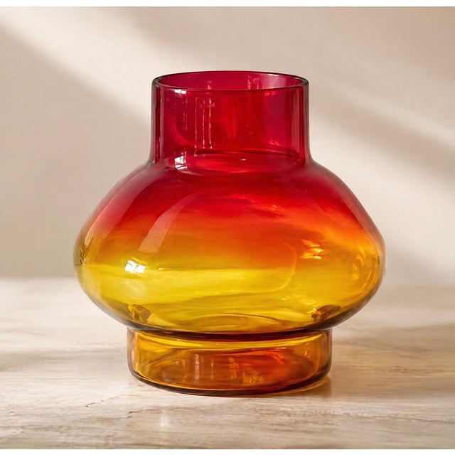 Offering a large blown glass foot vase. Introduce a burst of color to your space with this exquisite blown glass vase....