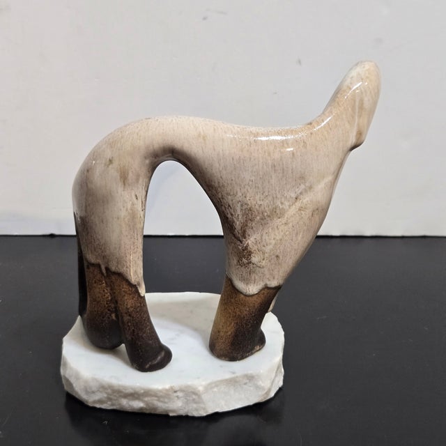 Maigon Daga ceramic Afghan Hound figurine showcases a sophisticated mid-century modern aesthetic with its stylized,...