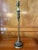 This elegant and slender Bombay Company lamp in the neoclassical style features a rich matte brass finish with black...