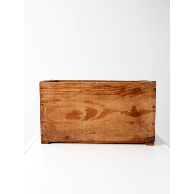 Vintage North Country orchard crate featuring a colorful fruit label set against warm wood tones. The classic orchard form...