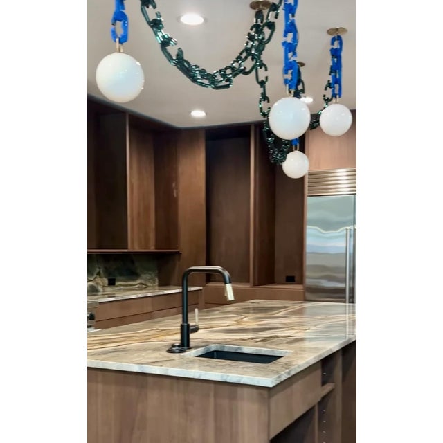 Dramatic in form, yet softened by the quiet elegance of glass, the Cerine Swagged Chandelier presents a unique opportunity...