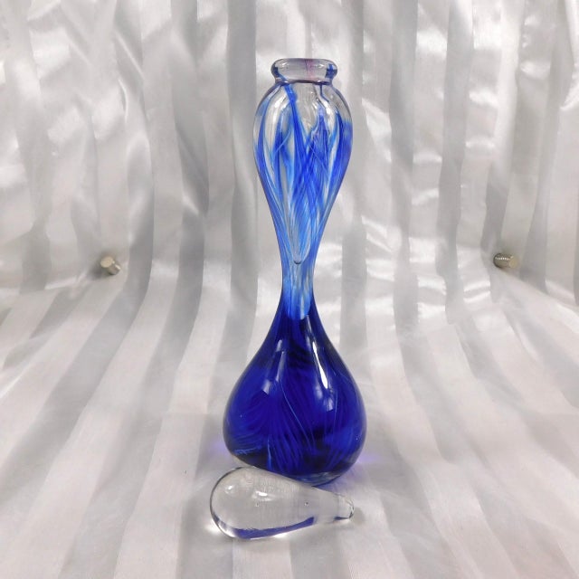 This is a tall blue signed art glass perfume bottle. The perfume space is only in the top half of the bottle. It comes...