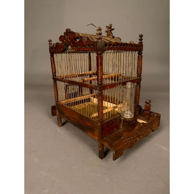 Fabulous French Folk Art finch bird cage, circa 1890, handcrafted in the late 19th century from fruitwood and steel. Rich...