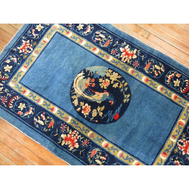 Stunning sky blue and ivory, navy accent full pile condition antique Chinese Peking rug, circa 1920. Floral border with...