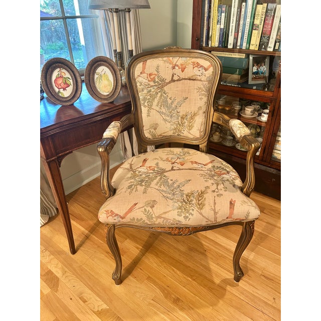 Late 20th century Italian Louis XV–style armchair featuring a carved hardwood frame with a warm antiqued finish. The chair...