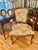 Late 20th century Italian Louis XV–style armchair featuring a carved hardwood frame with a warm antiqued finish. The chair...