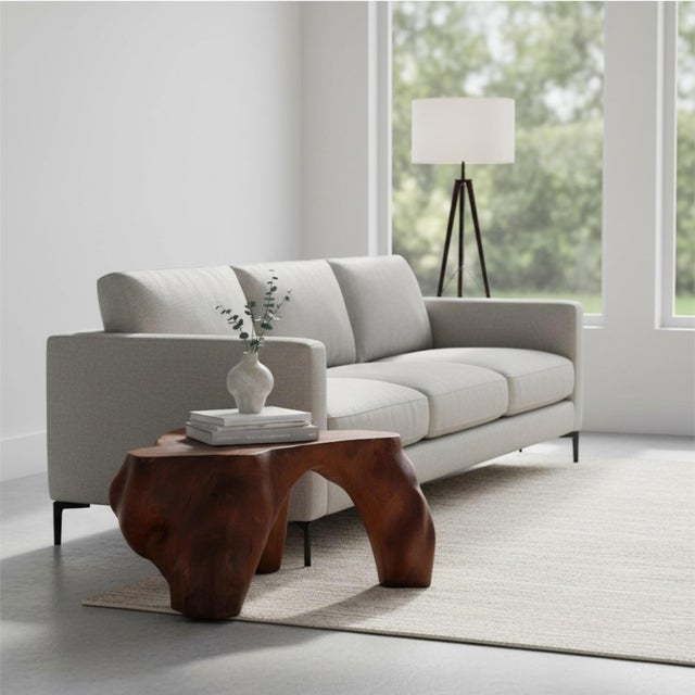 This sculptural solid‑wood side table is carved from a single block of timber, giving it a monolithic presence and a...