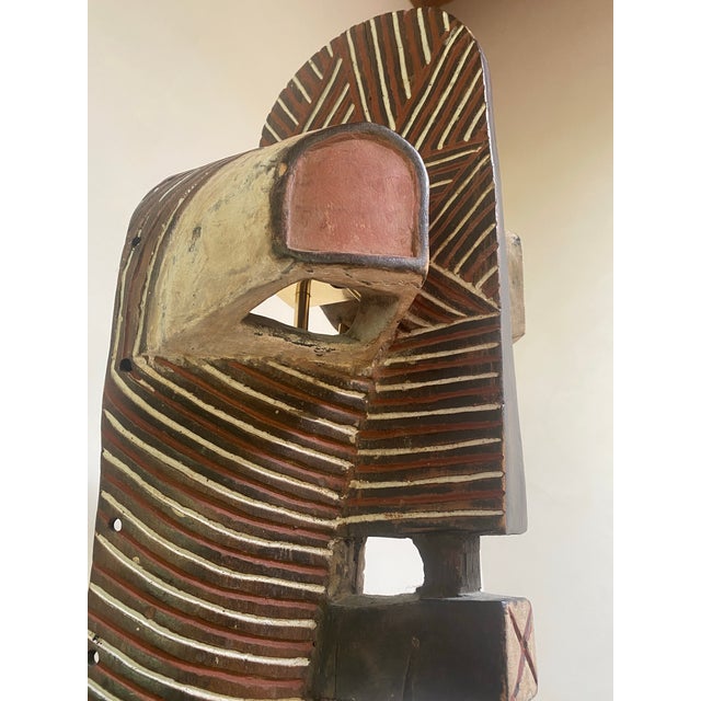 A striking carved-wood Songye kifwebe male mask (kilume) from the Democratic Republic of the Congo. The form is...