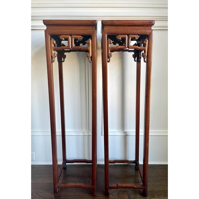 A pair of tall Chinese pedestal stands circa 19th century the late Qing dynasty. These types of stands were traditionally...