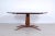 Mid-Century table in wood, oval top with interlocking glass. Attractive design reminiscent of the style of Paolo Buffa....