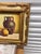 Subject: Still life depicting three traditional pottery jars in varying sizes and warm tones.Frame: Ornate, heavy gold-...